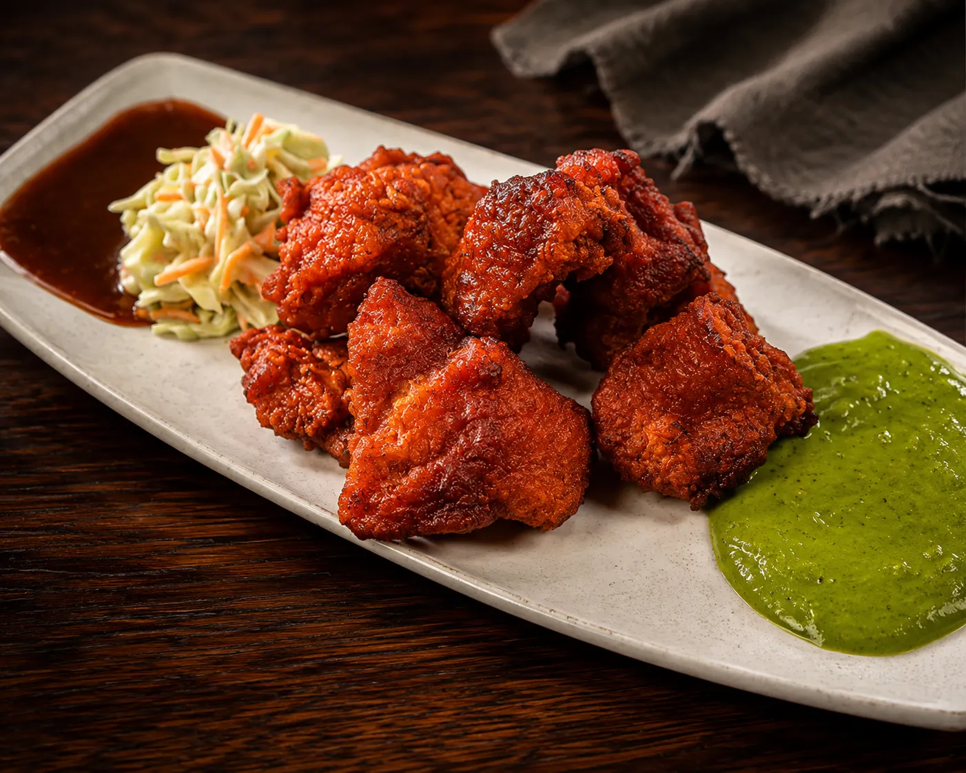 Crispy fish pakora appetizer with mint chutney and onions at Tamarind East Indian Restaurant Calgary