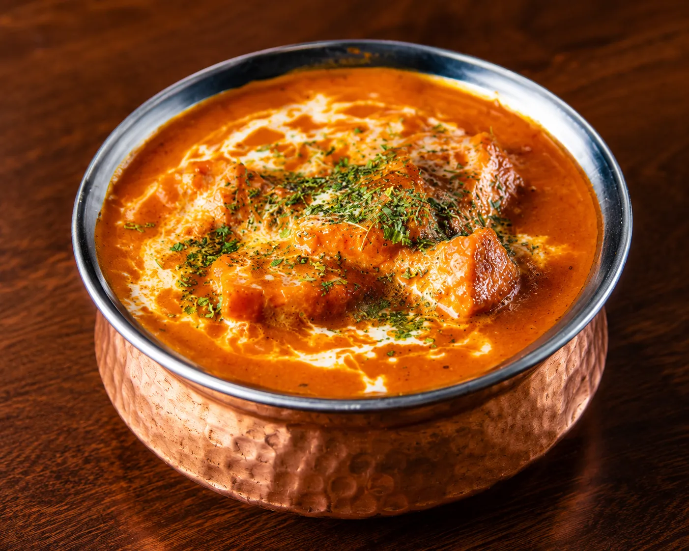 Butter chicken in a copper karahi with garlic naan at Tamarind East Indian Restaurant, Calgary
