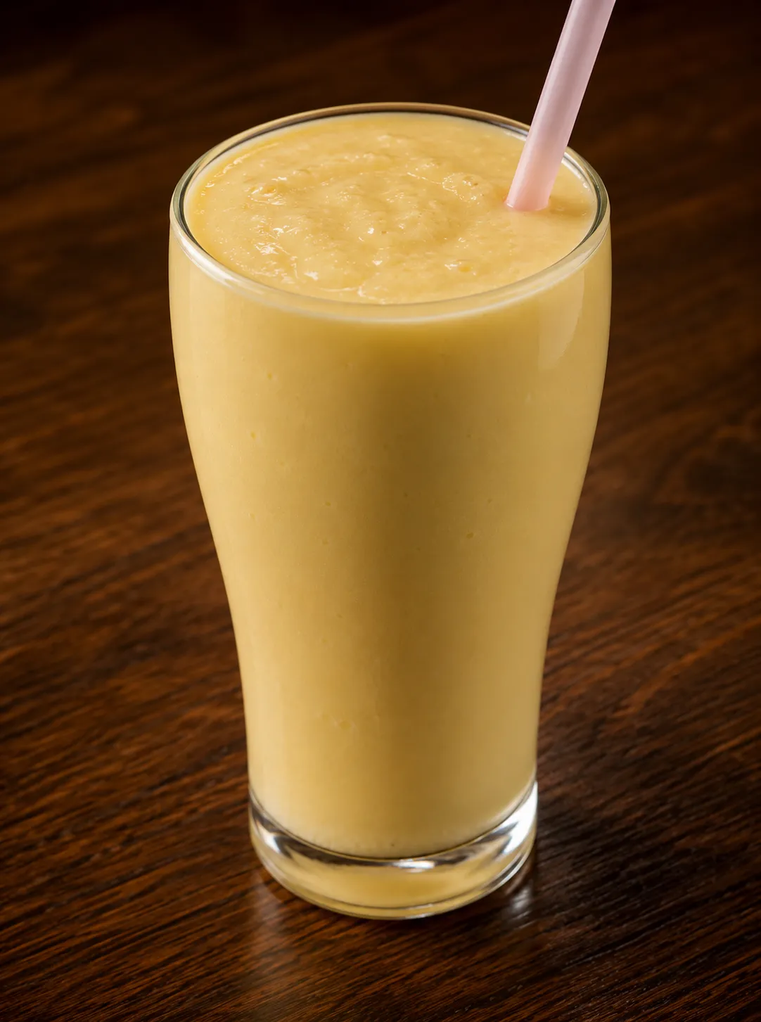 Tall glass of house-made mango lassi at Tamarind East Indian Restaurant, Calgary NW
